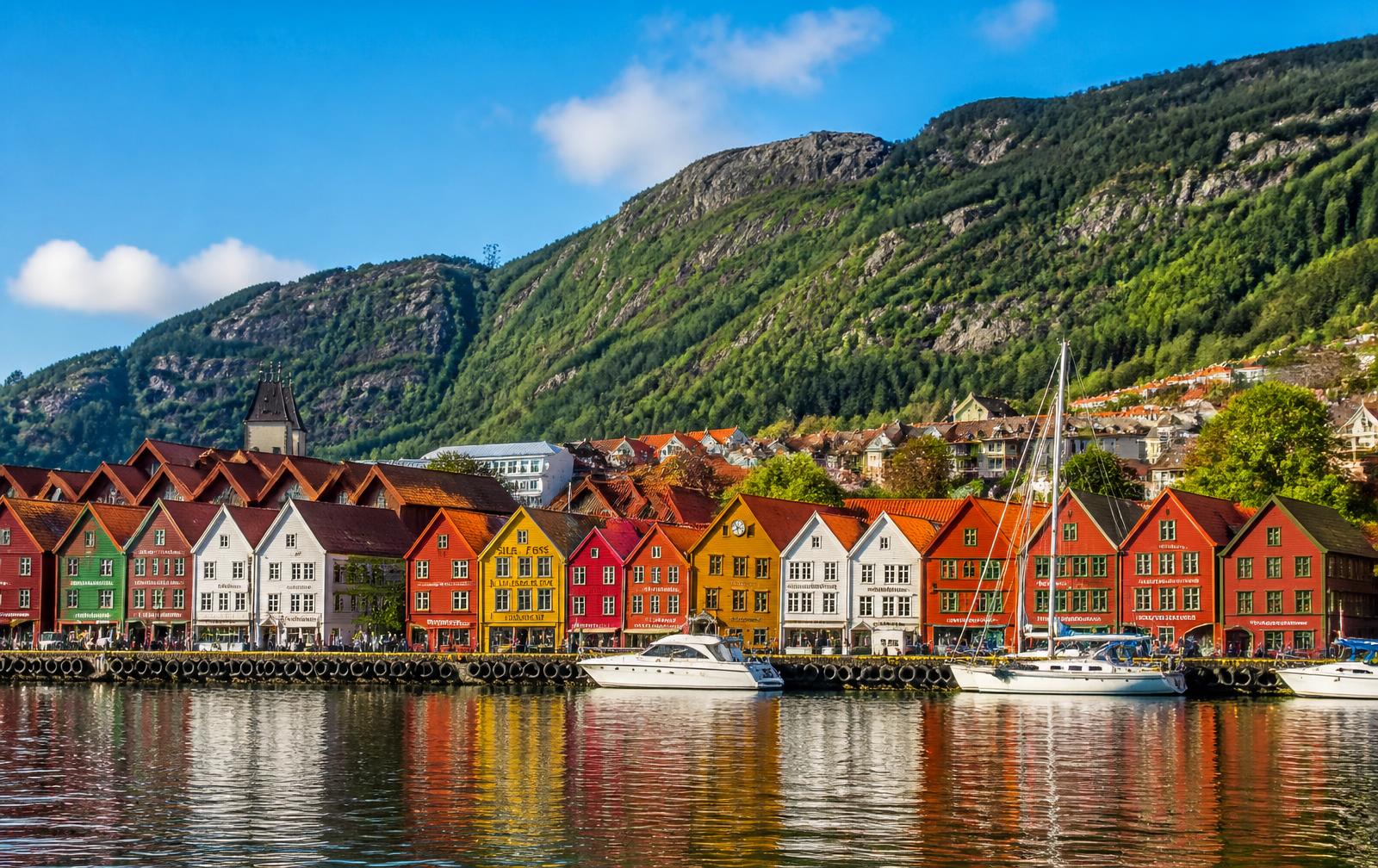 Bergen & Fjords Long Weekend — Colourful wooden harbour houses in Bergen under a blue sky