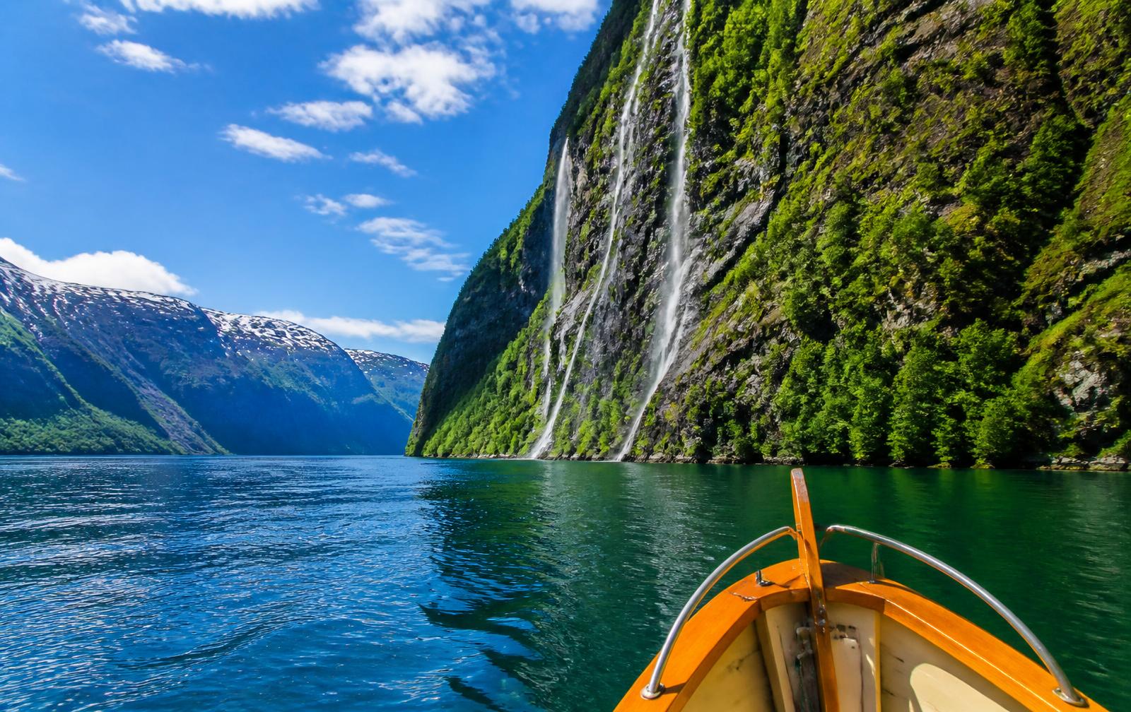 Private Fjord Day — Norwegian fjord with waterfalls, seen from the bow of a boat